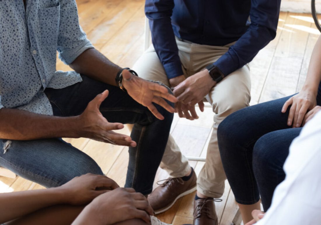 A family therapy session, people sitting together in conversation